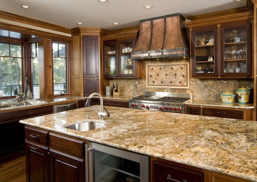 This modern kitchen has a granite counter island.